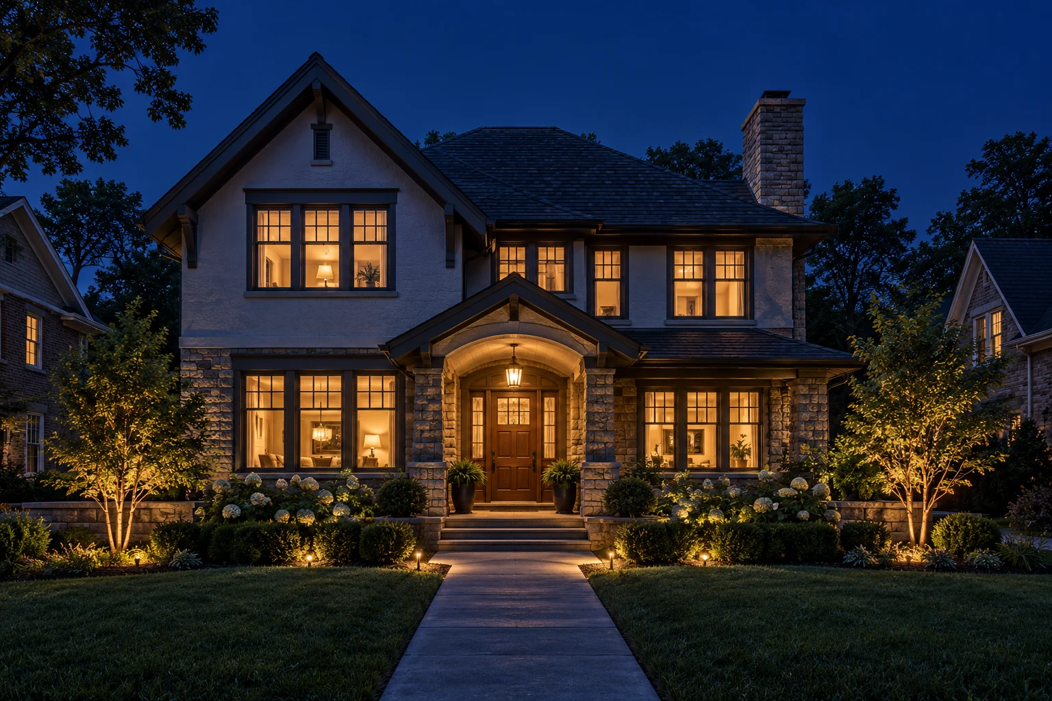 An older home with warmly lit windows at dusk